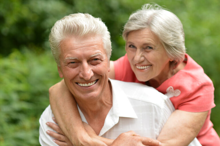 Happy older couple outside