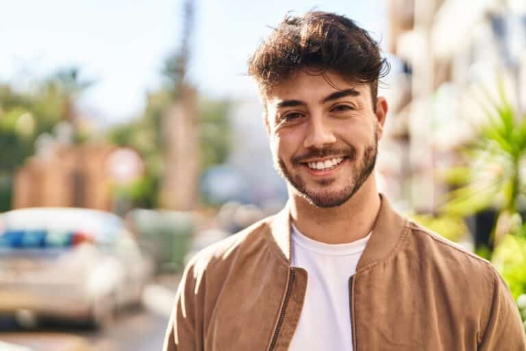 Happy young man outside on a city street